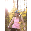 Pretty, young woman with her mountain bike going for a ride past the city limits, getting her dose of daily cardio