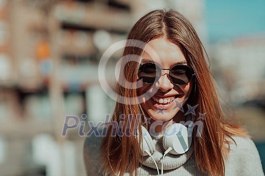 a woman in sunglasses enjoys a walk in the city while listening to music on her headphones