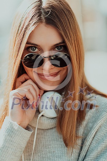 Close up of handsome young woman smiling while listening to music. Close up of handsome young woman smiling while listening to music.
