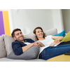 Portrait of young 25s just married couple in love posing photo shooting seated on couch in modern studio apartments, concept of capture happy moment, harmonic relationships, care and sincere feelings