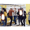 Group of business people having party and  throwing paper in air at modern coworking open space  startup office