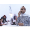 african muslim businesswoman using smart phone  wearing hijab at creative modern startup coworking open space office