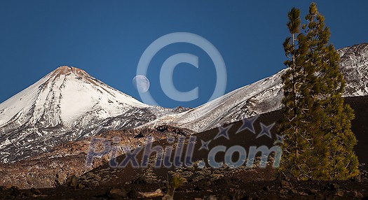 Colorful scenic landscape of moon rise in Tenerife national park of Teide. El Teide with moon rising by its side.