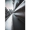 Fast moving car on a winter alpine snowy road