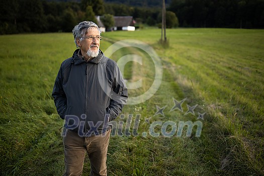 Senior man enjoying the outdoors, hiking, walking throught lovely nature Senior man enjoying the outdoors, hiking, walking throught lovely nature