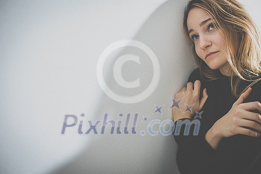 Depressed mid-aged woman at home feeling sad, lonely, anxious (color toned image) Depressed mid-aged woman at home feeling sad, lonely, anxious (color toned image)