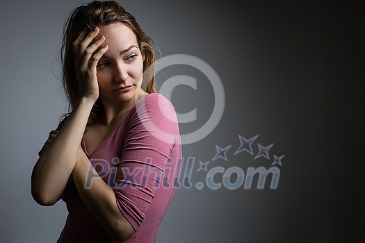 Depressed mid-aged woman at home feeling sad, lonely, anxious (color toned image)