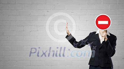 Businesswoman hiding her face behind mask and showing stop gesture Businesswoman hiding her face behind mask and showing stop gesture