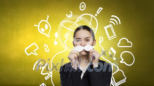 Happy cute girl trying male paper mustache Happy cute girl trying male paper mustache