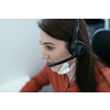 Female call center operator talking to a customer. Businesswoman in mask at the workplace in the  modern office. Social distance and safety outbreak new normal concept