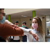 University students group greeting new normal coronavirus education lifestyle handshake and elbow bumping while wearing protective face masks