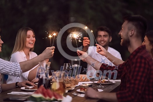 group of happy friends having picnic french dinner party outdoor during summer holiday vacation near the river at beautiful nature