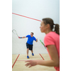 Squash players in action on a squash court (motion blurred image; color toned image)