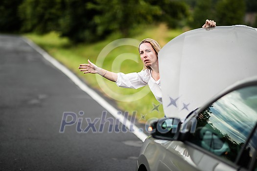 Pretty middle aged woman having car troubles - broken down car on the side of the road, calling the insurance company for assistance Pretty middle aged woman having car troubles - broken down car on the side of the road, calling the insurance company for assistance