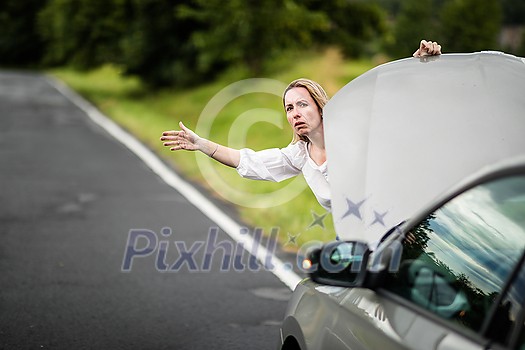 Pretty middle aged woman having car troubles - broken down car on the side of the road, calling the insurance company for assistance