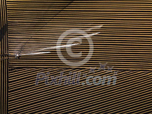 Intense agriculture fiekd being irrigatedwith huge amounts of water on a hot summer day - aerial image Intense agriculture fiekd being irrigatedwith huge amounts of water on a hot summer day - aerial image