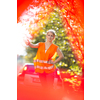 Young female driver wearing a high visibility vest, calling the roadside service/assistance after her car has broken down