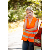 Young female driver wearing a high visibility vest, calling the roadside service/assistance after her car has broken down