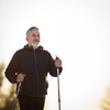 Senior man nordic walking outdoors on a snowy, winter day