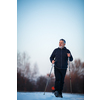 Senior man nordic walking outdoors on a snowy, winter day