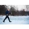 Senior man nordic walking outdoors on a snowy, winter day