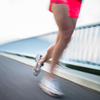 Young woman jogging outdoors (motion blurred image)