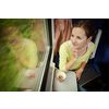 Young woman traveling by train (landscape moving fast behind the window (motion blurred image)