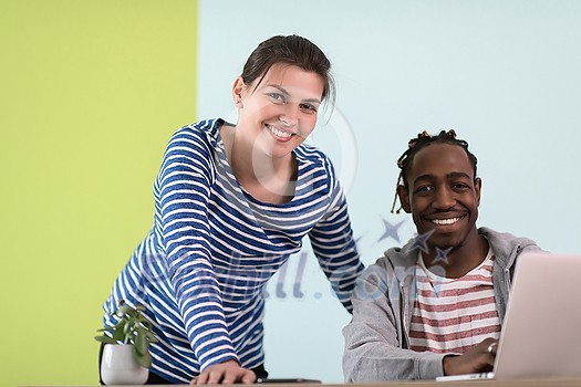 an african american and a young girl plan meetings together and use a laptop for an online meeting
