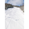 tracks on ski slopes in snow at beautiful sunny  winter day with blue sky