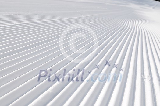 tracks on ski slopes in snow at beautiful sunny  winter day with blue sky