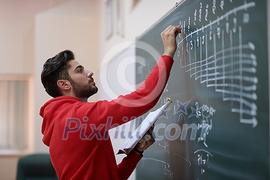 the student uses a book trying to make a math problem on the board