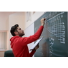 the student uses a book trying to make a math problem on the board