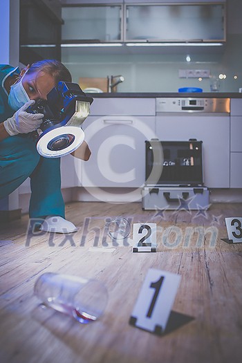 Forensic specialist in protective suit taking photos on a crime scene Forensic specialist in protective suit taking photos on a crime scene