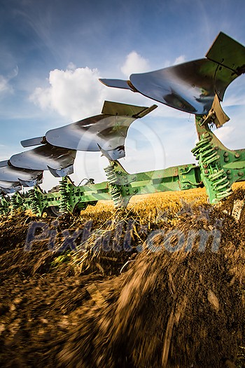 Tractors working on a farm field, - agricultural machines at work