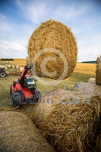 Tractors working on a farm field, - agricultural machines at work