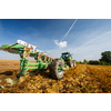 Tractor working on the farm, modern agricultural transport, farmer working in the field, tractor on a sunset background, cultivation of land, agricultural machine