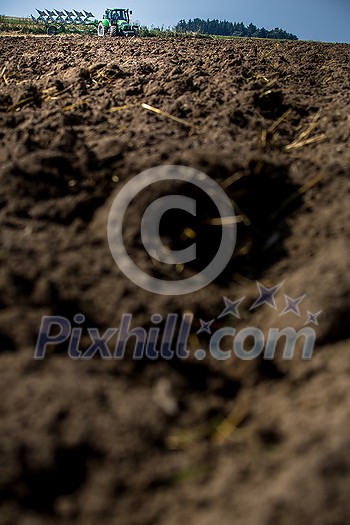 Tractor working on the farm, modern agricultural transport, farmer working in the field, tractor on a sunset background, cultivation of land, agricultural machine Tractor working on the farm, modern agricultural transport, farmer working in the field, tractor on a sunset background, cultivation of land, agricultural machine