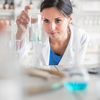 Young, female researcher carrying out experiments in a lab (shallow DOF; color toned image)