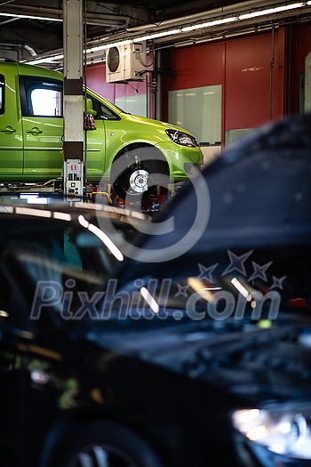 Tyre change - wheel balancing or repair and change car tire at auto service garage or workshop by mechanic Tyre change - wheel balancing or repair and change car tire at auto service garage or workshop by mechanic