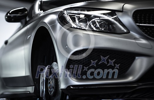 Tyre change - wheel balancing or repair and change car tire at auto service garage or workshop by mechanic Tyre change - wheel balancing or repair and change car tire at auto service garage or workshop by mechanic