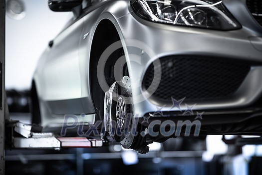 Tyre change - wheel balancing or repair and change car tire at auto service garage or workshop by mechanic Tyre change - wheel balancing or repair and change car tire at auto service garage or workshop by mechanic