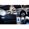 Tyre change - wheel balancing or repair and change car tire at auto service garage or workshop by mechanic