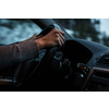 Driver's hands driving a car on a highway (color toned image; shallow DOF)