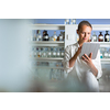 Portrait of a female researcher doing research in a lab, using a tablet computer for data collection and visualization(shallow DOF; color toned image)