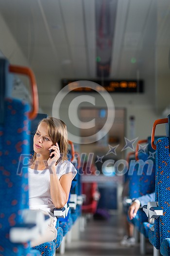 Young woman sitting in the train after a day of work . Train passenger traveling sitting relaxed and enjoying the ride