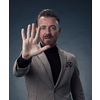 Portrait of a stylish elegant senior businessman with a beard and casual business clothes in photo studio isolated on dark background gesturing with hands. High quality photo