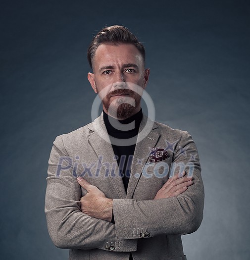 Portrait of a stylish elegant senior businessman with a beard and casual business clothes in photo studio isolated on dark background gesturing with hands. High quality photo Portrait of a stylish elegant senior businessman with a beard and casual business clothes in photo studio isolated on dark background gesturing with hands. High quality photo