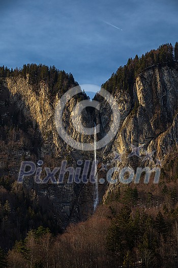 High waterfall within alpine scenery in Switzerland High waterfall within alpine scenery in Switzerland
