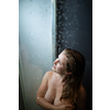 Pretty,young woman taking a long hot shower in a modern bathroom