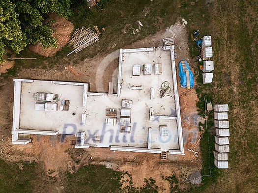 Aerial image of a new family house being built. New private housing development construction in rural countryside aerial view.